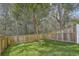 Spacious fenced backyard with lush green lawn and mature trees at 4678 Palm View Cir, North Charleston, SC 29418