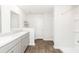 Bathroom featuring double sinks, wood-look flooring, and a shower with a white tile surround at 4678 Palm View Cir, North Charleston, SC 29418