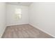 The empty bedroom has neutral carpet, white walls, and bright natural light at 4678 Palm View Cir, North Charleston, SC 29418