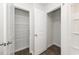 Bathroom with walk-in closets that have wire racks and wood-look flooring at 4678 Palm View Cir, North Charleston, SC 29418