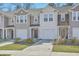 Well-manicured lawns and neutral siding enhances the townhome's curb appeal and charm at 4678 Palm View Cir, North Charleston, SC 29418