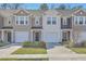 Charming townhomes with garages and well-maintained lawns offer curb appeal and convenient parking at 4678 Palm View Cir, North Charleston, SC 29418