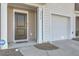 Close up of the front entrance, garage, and ADT security system of the townhome at 4678 Palm View Cir, North Charleston, SC 29418