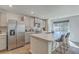 Bright kitchen boasts stainless steel appliances, granite countertops and a central island with barstool seating at 4678 Palm View Cir, North Charleston, SC 29418