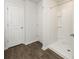 Bathroom features white tiled shower, wood-look flooring, and white trim at 4678 Palm View Cir, North Charleston, SC 29418