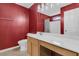 Bathroom with red wall, patterned tile floor, vanity with white top, shower and bathtub combo with curtain, and modern lighting fixture at 4808 Hearthside Dr, Summerville, SC 29485