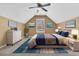 Cozy bedroom featuring a pitched ceiling, large window, stylish furniture, and decor with blue and brown color scheme at 4808 Hearthside Dr, Summerville, SC 29485