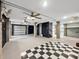 Unfinished basement area with concrete flooring, exposed ceiling ducts, and multiple garage doors at 524 Amalie Farms Dr, Charleston, SC 29492