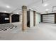 A spacious unfinished basement with exposed ducts and concrete floors with a painted checkerboard accent at 524 Amalie Farms Dr, Charleston, SC 29492