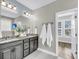 Bathroom with double sinks, granite countertops, and a tiled floor at 524 Amalie Farms Dr, Charleston, SC 29492