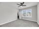 This spacious bedroom includes plush gray carpeting and a lighted ceiling fan at 524 Amalie Farms Dr, Charleston, SC 29492