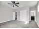 Spacious bedroom with neutral carpet and a view to bathroom and stairs at 524 Amalie Farms Dr, Charleston, SC 29492