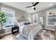 Bright bedroom features two windows, ceiling fan, and a modern rug at 524 Amalie Farms Dr, Charleston, SC 29492