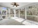 Screened porch with white railings and a wooded view at 524 Amalie Farms Dr, Charleston, SC 29492
