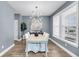 Bright dining room with modern chandelier, stylish table, and views of a manicured yard at 524 Amalie Farms Dr, Charleston, SC 29492