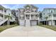 Charming elevated home featuring a spacious driveway and eye-catching red shutters at 524 Amalie Farms Dr, Charleston, SC 29492