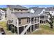 Rear exterior of home, showcasing the second story screened-in porch and exterior staircase at 524 Amalie Farms Dr, Charleston, SC 29492