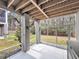 Screened in back patio featuring an outdoor light fixture and views of the wooded backyard at 524 Amalie Farms Dr, Charleston, SC 29492