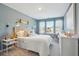 Comfortable bedroom with white bedding, a wall-mounted light and a three-panel window at 5567 Ruby Falls Drive Ln, North Charleston, SC 29420