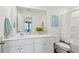 Well-lit bathroom with a bright vanity, modern sink, and tub/shower with white curtain and patterned towels at 5569 Ruby Falls Drive Ln, North Charleston, SC 29420