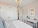 Inviting bedroom with patterned wallpaper, white vanity and stool, and decorative mirror at 5569 Ruby Falls Drive Ln, North Charleston, SC 29420