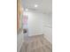 Light-filled hallway with carpet flooring, artwork, and a view into a sunlit room, creating an inviting passage at 5569 Ruby Falls Drive Ln, North Charleston, SC 29420