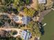Aerial view of a house with a dark roof, surrounded by trees and a dock at 601 Foredeck Ln, Edisto Island, SC 29438
