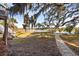 Serene backyard with a stone path leading to water with trees and a private dock at 601 Foredeck Ln, Edisto Island, SC 29438