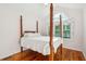 Charming bedroom with hardwood floors, arched window, and a four-poster bed at 601 Foredeck Ln, Edisto Island, SC 29438