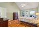 Bright bedroom with hardwood floors, a bed, dresser, and views of the outside patio from the windows at 601 Foredeck Ln, Edisto Island, SC 29438