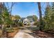 Charming two-story home with a well-maintained lawn and surrounding trees at 601 Foredeck Ln, Edisto Island, SC 29438