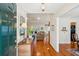 Inviting foyer with hardwood floors, a decorative mirror, and a glimpse into the living area at 601 Foredeck Ln, Edisto Island, SC 29438