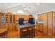 Well-lit kitchen features an island with barstool seating, wood cabinets and black appliances at 601 Foredeck Ln, Edisto Island, SC 29438