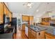 Kitchen with an island, black appliances and a seamless transition into the cozy living room at 601 Foredeck Ln, Edisto Island, SC 29438