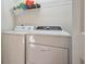 A laundry room with white washer and dryer and shelf for supplies at 601 Foredeck Ln, Edisto Island, SC 29438
