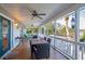 Covered patio with a dining table and fan, perfect for outdoor entertaining or enjoying a meal at 601 Foredeck Ln, Edisto Island, SC 29438