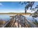 A serene wooden pier extending into a tranquil waterway, perfect for relaxation at 601 Foredeck Ln, Edisto Island, SC 29438