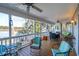 Spacious covered porch with ample seating overlooking a scenic water view and lush landscaping at 601 Foredeck Ln, Edisto Island, SC 29438