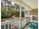 A green porch with chairs overlooking a front yard at 601 Foredeck Ln, Edisto Island, SC 29438