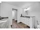 Bright bathroom featuring a white vanity with a gray countertop and dark wood flooring at 601 Pompano Rd, Edisto Island, SC 29438