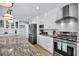 Bright kitchen with white cabinets, stainless steel appliances, and stone countertops at 601 Pompano Rd, Edisto Island, SC 29438