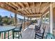 The inviting porch features comfortable seating with neighborhood views and a wooden ceiling at 601 Pompano Rd, Edisto Island, SC 29438