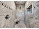 Stone tiled shower with a built-in bench and a convenient recessed shelf at 601 Pompano Rd, Edisto Island, SC 29438