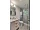 Bathroom featuring marble vanity, toilet, glass shower, and decorative gray tiled floor at 7 Logan St # F, Charleston, SC 29401