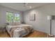 Inviting bedroom features natural light, hardwood floors, and comfy bedding at 7 Logan St # F, Charleston, SC 29401