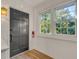 Inviting entryway featuring a stylish door, hardwood floors, and natural light at 7 Logan St # F, Charleston, SC 29401
