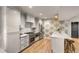 Well-lit kitchen featuring modern cabinets, stainless steel appliances, and a stylish breakfast bar at 7 Logan St # F, Charleston, SC 29401