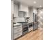 Modern kitchen with stainless steel appliances, custom cabinetry, and bright counters at 7 Logan St # F, Charleston, SC 29401