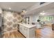 Kitchen featuring quartz countertops, brass fixtures, and seamless flow to living area at 7 Logan St # F, Charleston, SC 29401