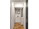 A well organized laundry closet with white cabinets and modern fixtures at 7 Logan St # F, Charleston, SC 29401